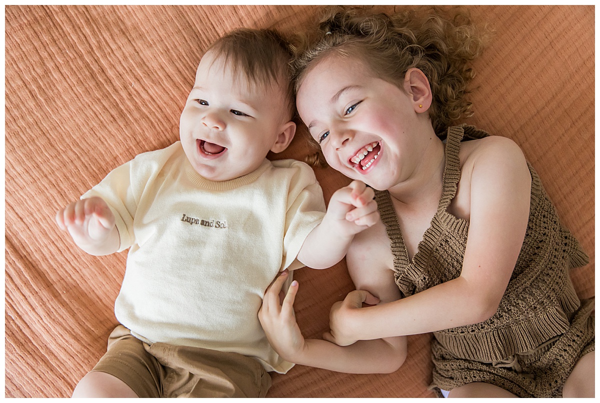 laughing siblings